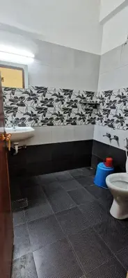 a bathroom with a sink and a toilet at Munnar House in Munnar