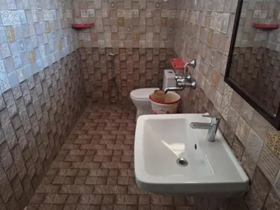 a bathroom with a sink and a toilet at Golden Gate Luxury Villas by LexStays in Ooty