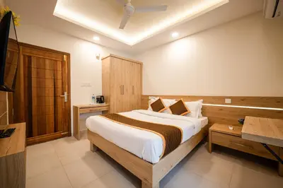 a bedroom with a large bed in a room at Daan Temple Inn in Guruvāyūr