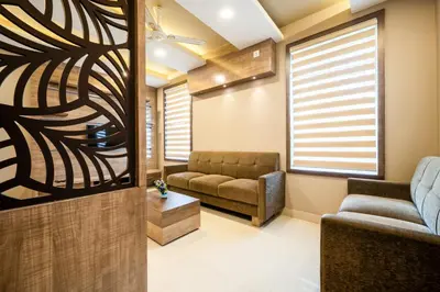 a living room with a couch and a chair at Daan Temple Inn in Guruvāyūr