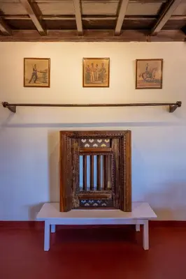 a wooden frame sitting on a table in a room at Sliceinn Escapes Pushpanjali - Madikeri, Coorg in Madikeri