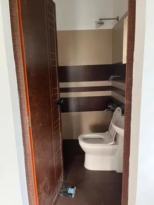 a bathroom with a toilet and a sink at Fully furnished 3BHK 2 Floor Villa in Angamali