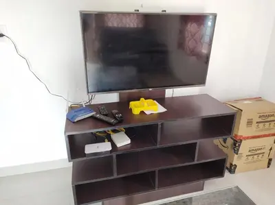 a brown entertainment center with a tv on top at Fully furnished 3BHK 2 Floor Villa in Angamali