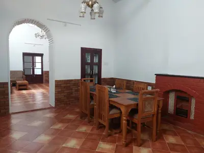 a dining room with a table and a fireplace at Jennings Abode Doddabetta in Ooty