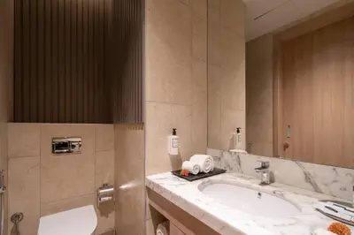 a bathroom with a sink and a large mirror at The Magnus in Coimbatore