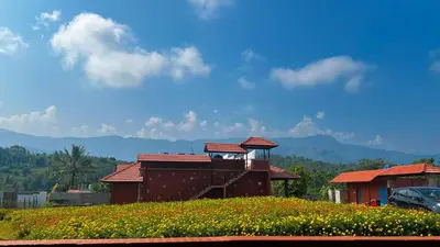 a house on top of a field of flowers at Mana Gramam Resort Mudumalai- Only For Indians,NRI in Mudumalai National Park