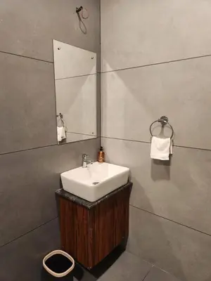 a bathroom with a sink and a mirror at Mana Gramam Resort Mudumalai- Only For Indians,NRI in Mudumalai National Park
