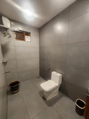 a bathroom with a white toilet in a room at Mana Gramam Resort Mudumalai- Only For Indians,NRI in Mudumalai National Park