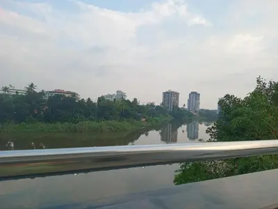 a view of a river with buildings in the background at Dew Dreams Periyar Castle in Alwaye