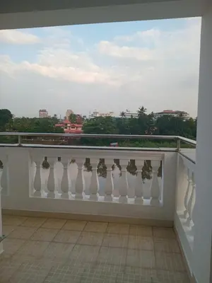 a balcony with a white railing and a view of the city at Dew Dreams Periyar Castle in Alwaye