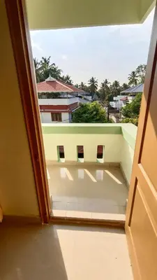 a view from an open window of a building at Serenity Suite in Trichūr