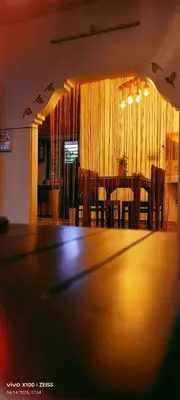 a table in a room with a dining room at The Bulbul Nest Homestay in Gūdalūr