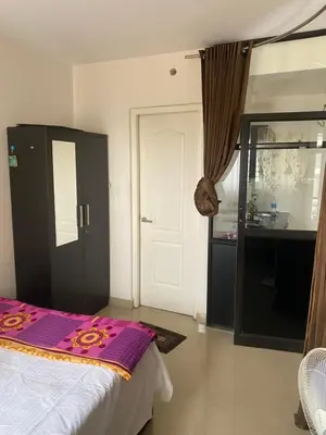 a bedroom with a bed and a door to a kitchen at Peace of mind in Kakkayam