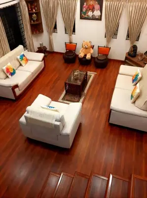 a living room with white couches and a teddy bear at Greendale in Kotagiri