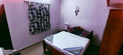 a small bedroom with a small bed in it at The Bulbul Nest Homestay in Gūdalūr