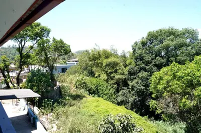 a view of a garden with a bench and trees at Lands End in Madikeri