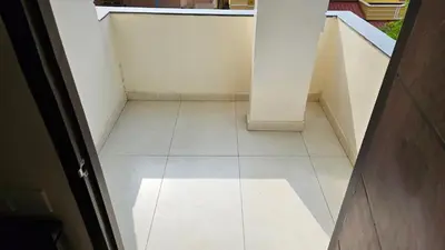an empty hallway with a white tile floor at Mookambika Serviced Apartment in Coimbatore