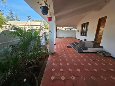 a living room of a house with a red tiled floor at SHI's Shenba 3BHk Villa Near Ganga Hospital Coimbatore in Coimbatore