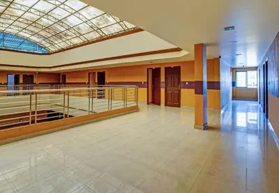 a large room with a gym with a glass ceiling at Marhaba tourist home in Kunnamangalam