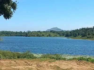 a large body of water with mountains in the background at Wintervilla Cottages in Meppādi