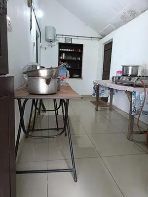 a kitchen with a table with a large pot on it at Wintervilla Cottages in Meppādi