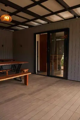 an empty room with a table and a bench at Trumpet Deck in Kutta
