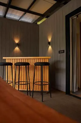 a bar in a room with two stools at Trumpet Deck in Kutta