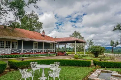 a house with a table and chairs in the yard at Villa Fair Winds, Sirukundra Estate in Vālpārai