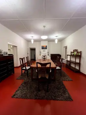 a dining room with a table and chairs at Villa Fair Winds, Sirukundra Estate in Vālpārai
