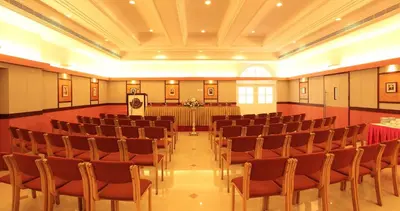 a large room with chairs and a podium in it at Hotel Luciya Palace in Trichūr