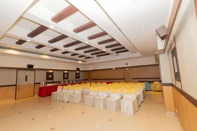 a large room with rows of tables and chairs at Hotel Luciya Palace in Trichūr