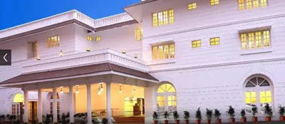 a large white building with lights on at Hotel Luciya Palace in Trichūr