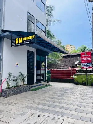 a building with a sign for a sushi restaurant at SN RESiDENCY in Kozhikode