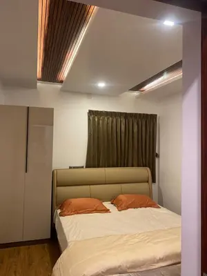 a bedroom with a large bed in front of a window at eagle resort in Ketti