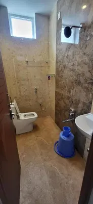 a bathroom with a toilet and a sink at eagle resort in Ketti