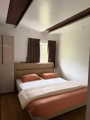 a bedroom with a bed with two pillows on it at eagle resort in Ketti