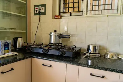 a kitchen with a stove with a pot on it at Akshaya - Charming 2BHK apartment with scenic view in Mysore