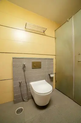a bathroom with a toilet and a shower stall at Senaro Luxury Farm in Agali