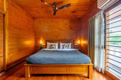 a bedroom with a bed in a wooden room at Senaro Luxury Farm in Agali