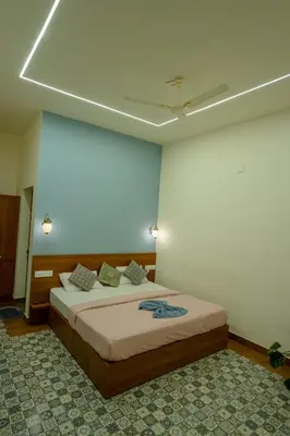a bedroom with a large bed in a room at Swastha Royal Resort Wayanad in Kaniyāmbetta