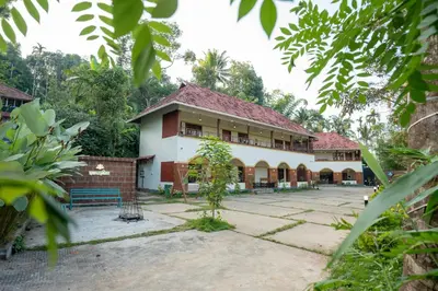 a house in the middle of a garden at Swastha Royal Resort Wayanad in Kaniyāmbetta