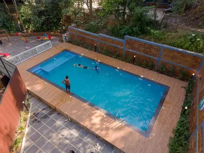 an overhead view of a man standing in a swimming pool at Swastha Royal Resort Wayanad in Kaniyāmbetta