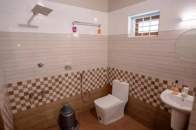 a bathroom with a toilet and a sink at Swastha Heritage Homestays Wayanad in Kaniyāmbetta