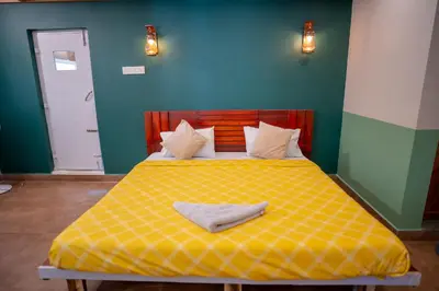 a bedroom with a yellow bed with a yellow blanket at Swastha Heritage Homestays Wayanad in Kaniyāmbetta