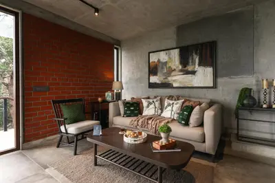 a living room with a couch and a table at LohonoStays Amani Villa 11A in Coonoor