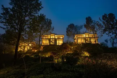 a large house lit up at night at LohonoStays Amani Villa 11A in Coonoor