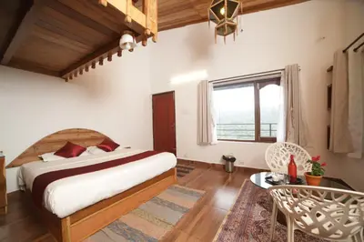 a bedroom with a large bed and a window at Eagle Woods Kookal in Kūkkāl