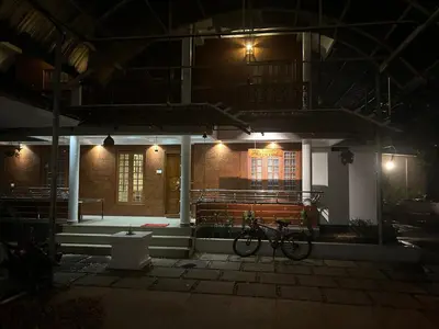a bike parked in front of a building at night at Kappazha Tharavadu in Alwaye