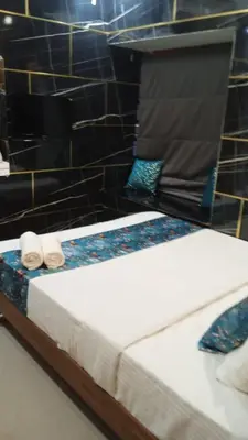 a bed with two towels on top of it at Kappazha Tharavadu in Alwaye