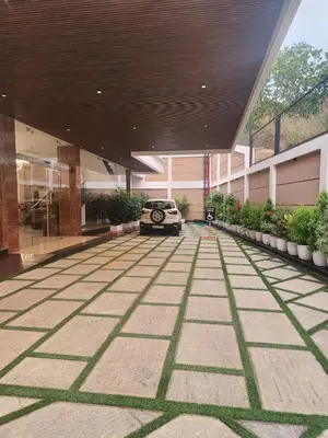 a car parked in a parking lot in a building at VV's Lakshmi Inn in Thekkumkara